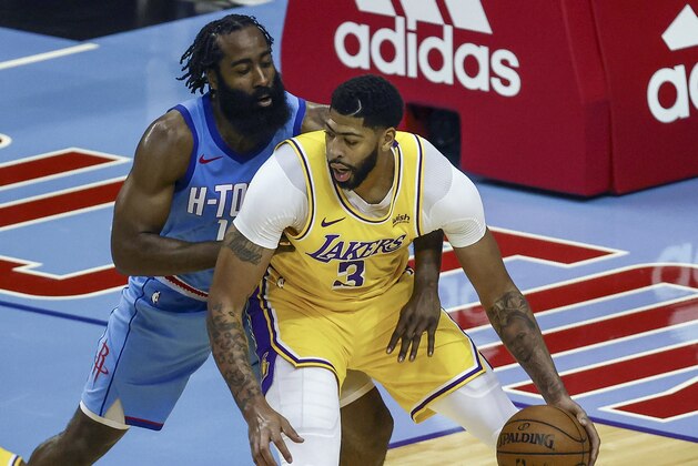 Los Angeles Lakers forward Anthony Davis (3) controls the ball against Houston Rockets guard James Harden during the third quarter of an NBA basketball game Tuesday, Jan. 21, 2021, in Houston. (Troy Taormina/Pool Photo via AP)