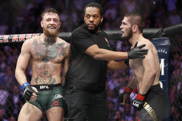 FILE - In this Oct. 6, 2018, file photo, Conor McGregor, left, fights Khabib Nurmagomedov are separated during a UFC 229 mixed martial arts bout in Las Vegas. Nurmagomedov was fined $500,000 and suspended for nine months for a brawl inside and outside the octagon after his fight with Conor McGregor at UFC 229. McGregor was fined $50,000 and suspended for six months.  The suspensions for both fighters are retroactive to Oct. 6. (AP Photo/John Locher, File)