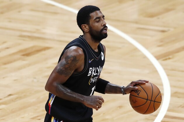 Brooklyn Nets' Kyrie Irving plays against the Boston Celtics during the first half of an NBA basketball game, Friday, Dec. 25, 2020, in Boston. (AP Photo/Michael Dwyer)