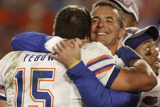 FILE - In this Jan. 8, 2009, file photo, Florida's Tim Tebow is hugged by coach Urban Meyer after Florida defeated Oklahoma 24-14 in the BCS Championship NCAA college football game, in Miami. The Associated Press has been ranking the best teams in college football for the last 80 seasons. (AP Photo/Chris O'Meara, File)