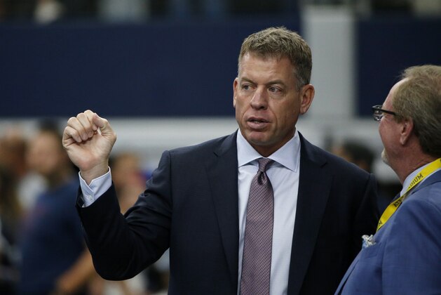 Broadcast personality Troy Aikman, left, talks with sports reporter Ed Werder, right, before a NFL football game between eh New York Giants and Dallas Cowboys in Arlington, Texas, Sunday, Sept. 8, 2019. (AP Photo/Michael Ainsworth)