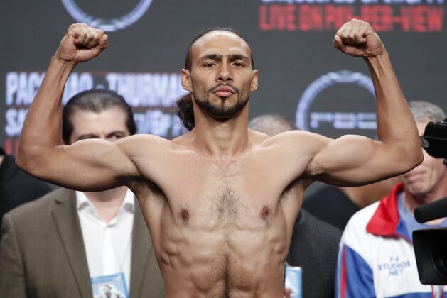 Keith Thurman poses on the scale during a weigh-in Friday, July 19, 2019, in Las Vegas. Thurman is scheduled to fight Manny Pacquiao in a welterweight championship boxing match Saturday in Las Vegas. (AP Photo/John Locher)