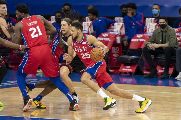 Philadelphia 76ers' Ben Simmons, right, drives to the basket against Miami Heat's Kelly Olynyk, left, during the first half of an NBA basketball game, Thursday, Jan. 14, 2021, in Philadelphia. (AP Photo/Chris Szagola)