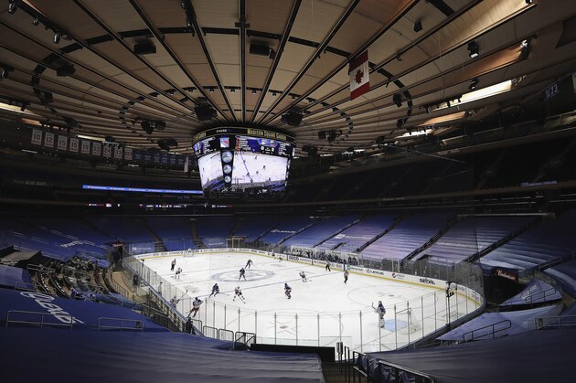 In an empty Madison Square Garden, the New York Rangers play the New York Islanders in an NHL hockey game Thursday, Jan. 14, 2021, in New York. (Bruce Bennett/Pool Photo via AP)
