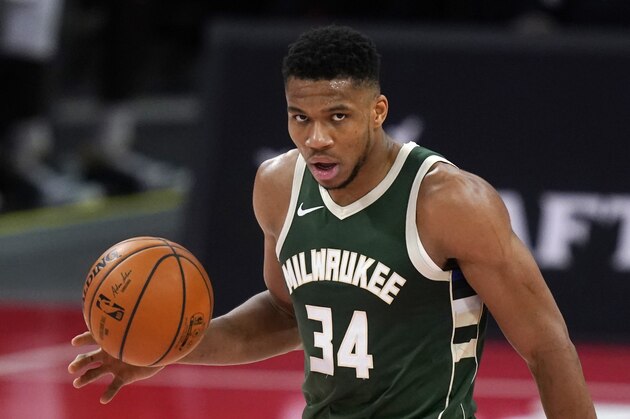 Milwaukee Bucks forward Giannis Antetokounmpo brings the ball up court during the first half of an NBA basketball game against the Detroit Pistons, Wednesday, Jan. 13, 2021, in Detroit. (AP Photo/Carlos Osorio)