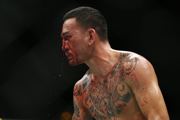Max Holloway fights Dustin Poirier during an interim lightweight title mixed martial arts bout at UFC 236 in Atlanta, early Sunday, April 14, 2019. (AP Photo/Michael Zarrilli)