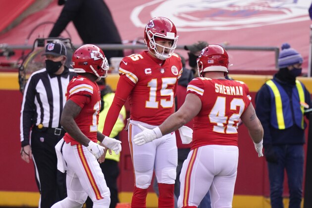 Kansas City Chiefs quarterback Patrick Mahomes (15) celebrates with teammates after scoring on a touchdown run during the first half of an NFL divisional round football game against the Cleveland Browns, Sunday, Jan. 17, 2021, in Kansas City. (AP Photo/Charlie Riedel)