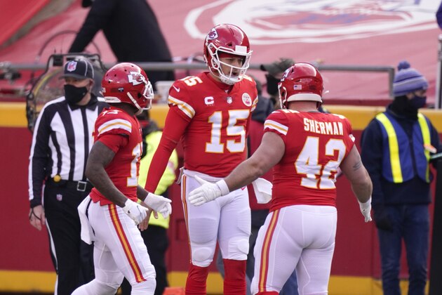 Kansas City Chiefs quarterback Patrick Mahomes (15) celebrates with teammates after scoring on a touchdown run during the first half of an NFL divisional round football game against the Cleveland Browns, Sunday, Jan. 17, 2021, in Kansas City. (AP Photo/Charlie Riedel)