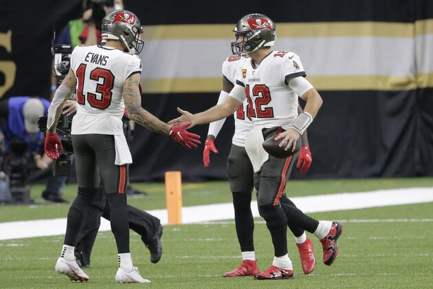 Tampa Bay Buccaneers quarterback Tom Brady (12) celebrates his touchdown with wide receiver Mike Evans (13) during the second half of an NFL divisional round playoff football game against the New Orleans Saints, Sunday, Jan. 17, 2021, in New Orleans. (AP Photo/Brett Duke) Tampa Bay Buccaneers quarterback Tom Brady (12) celebrates his touchdown with wide receiver Mike Evans (13) during the second half of an NFL divisional round playoff football game against the New Orleans Saints, Sunday, Jan. 17, 2021, in New Orleans. (AP Photo/Brett Duke)