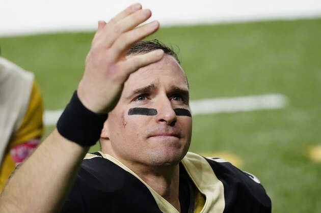 New Orleans Saints quarterback Drew Brees waves to his family and fans after an NFL divisional round playoff football game against the Tampa Bay Buccaneers, Sunday, Jan. 17, 2021, in New Orleans. The Buccaneers won 30-20. (AP Photo/Brynn Anderson)