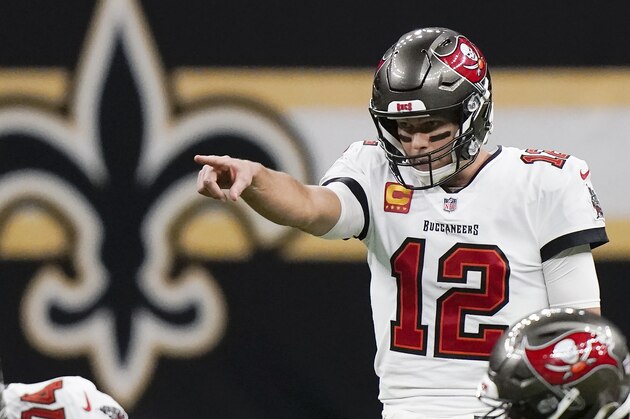 Tampa Bay Buccaneers quarterback Tom Brady (12) signals at the line of scrimmage against the New Orleans Saints during the first half of an NFL divisional round playoff football game, Sunday, Jan. 17, 2021, in New Orleans. (AP Photo/Brynn Anderson)