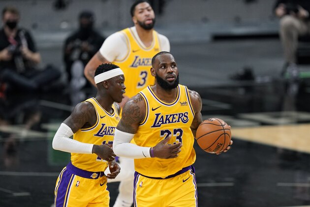 Los Angeles Lakers forward LeBron James (23), guard Dennis Schroder (17) and forward Anthony Davis (3) during the second half of an NBA basketball game in San Antonio, Wednesday, Dec. 30, 2020. (AP Photo/Eric Gay)