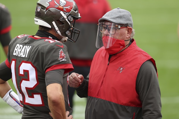 Tampa Bay Buccaneers head coach Bruce Arians talks to quarterback Tom Brady (12) before an NFL football game against the Atlanta Falcons Sunday, Jan. 3, 2021, in Tampa, Fla. (AP Photo/Mark LoMoglio)