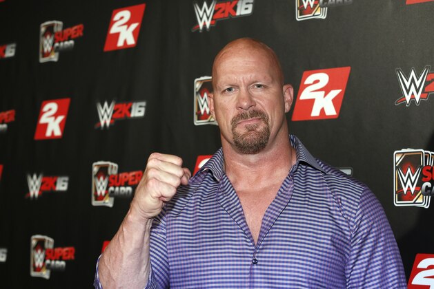 IMAGE DISTRIBUTED FOR 2K - WWE Hall of Famer and WWE 2K16 cover, Superstar Stone Cold Steve Austin arrives on the red carpet at the WWE 2K SummerSlam Kickoff in New York, N.Y., on Thursday, Aug. 20, 2015. (Photo by Stuart Ramson/Invision for 2K/AP Images)