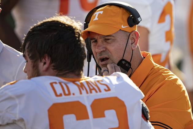 Tennessee head coach Jeremy Pruitt, right, talks with offensive lineman Cooper Mays (63) during the first half of an NCAA college football game against Vanderbilt, Saturday, Dec. 12, 2020, in Nashville, Tenn. (AP Photo/Wade Payne)