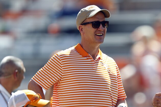 Former Denver Bronco's quarterback Peyton Manning, center and his son Marshall Manning talk with Tennessee head coach Jeremy Pruitt before an NCAA college football game against Georgia State Saturday, Aug. 31, 2019, in Knoxville, Tenn. (AP Photo/Wade Payne)