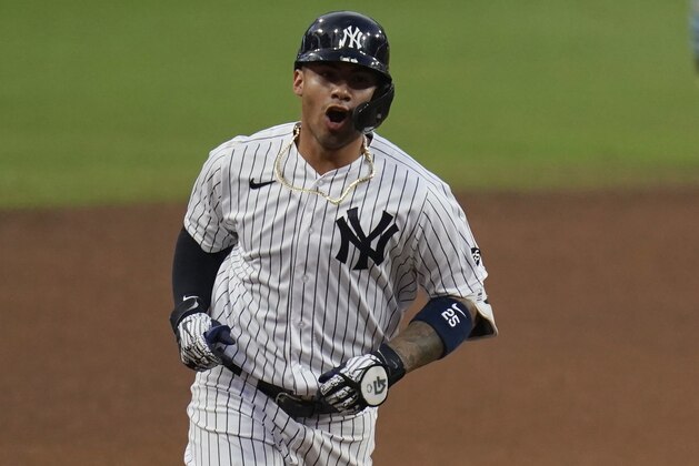 New York Yankees' Gleyber Torres reacts as he rounds the bases after hitting a two-run home run to score Brett Gardner during the sixth inning in Game 4 of a baseball American League Division Series against the Tampa Bay Rays, Thursday, Oct. 8, 2020, in San Diego. (AP Photo/Gregory Bull)