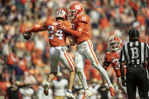 Clemson safety Nolan Turner (24) celebrates an interception with teammate Joseph Charleston (18) during the first half of an NCAA college football game against Boston College Saturday, Oct. 31, 2020, in Clemson, S.C. (Josh Morgan/Pool Photo via AP)