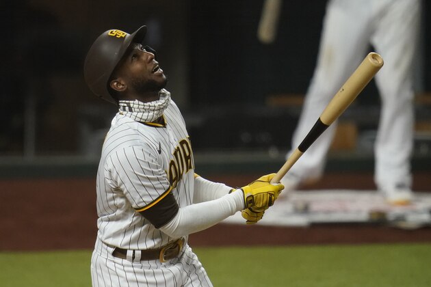 San Diego Padres' Jurickson Profar watches his ball during an at-bat in Game 3 of a baseball National League Division Series against the Los Angeles Dodgers Thursday, Oct. 8, 2020, in Arlington, Texas. (AP Photo/Sue Ogrocki)