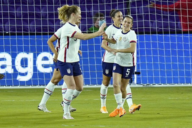 United States midfielder Samantha Mewis, left, celebrates after scoring a goal against Colombia with defender Kelly O'Hara, right, during the first half of an international friendly soccer match, Monday, Jan. 18, 2021, in Orlando, Fla. (AP Photo/John Raoux)