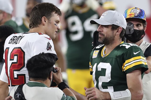 Tampa Bay Buccaneers quarterback Tom Brady, left, shakes hands with Green Bay Packers quarterback Aaron Rodgers after the Bucs defeated the Packers during an NFL football game Sunday, Oct. 18, 2020, in Tampa, Fla. (AP Photo/Mark LoMoglio)
