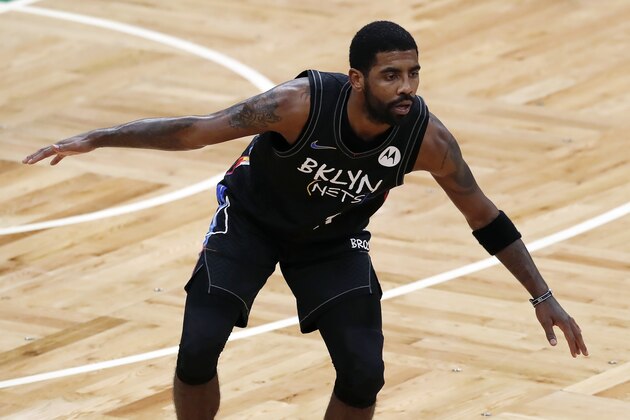 Brooklyn Nets' Kyrie Irving plays against the Boston Celtics during the first half of an NBA basketball game, Friday, Dec. 25, 2020, in Boston. (AP Photo/Michael Dwyer)