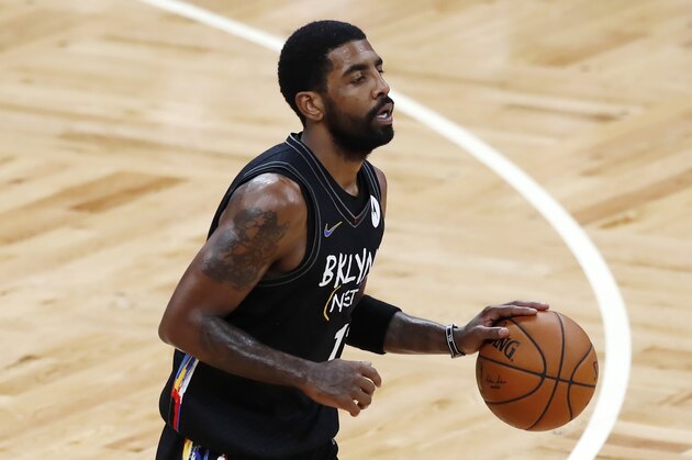 Brooklyn Nets' Kyrie Irving plays against the Boston Celtics during the first half of an NBA basketball game, Friday, Dec. 25, 2020, in Boston. (AP Photo/Michael Dwyer)