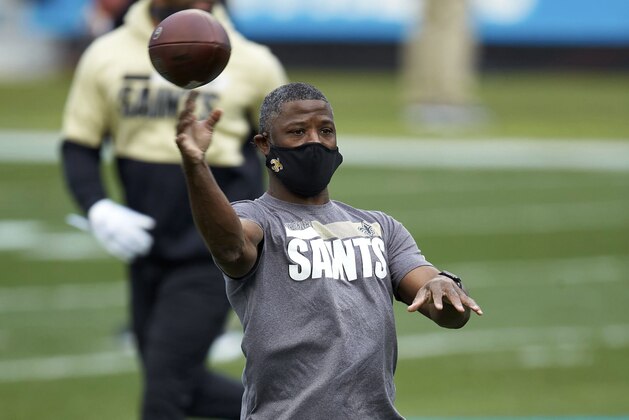 FILE - In this Jan. 3, 2021, file photo, New Orleans Saints secondary coach Aaron Glenn throws prior to an NFL football game against the Carolina Panthers in Charlotte, N.C. The New York Jets interviewed Tennessee Titans offensive coordinator Arthur Smith and Glenn on Monday, Jan. 11, 2021, for their head coaching vacancy. (AP Photo/Brian Westerholt, File)