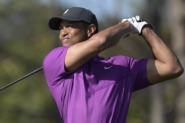 Tiger Woods watches his tee shot on the first hole during the first round of the PNC Championship golf tournament, Saturday, Dec. 19, 2020, in Orlando, Fla. (AP Photo/Phelan M. Ebenhack)
