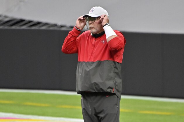Tampa Bay Buccaneers head coach Bruce Arians adjusts a face shield before an NFL football game against the Las Vegas Raiders, Sunday, Oct. 25, 2020, in Las Vegas. (AP Photo/David Becker)