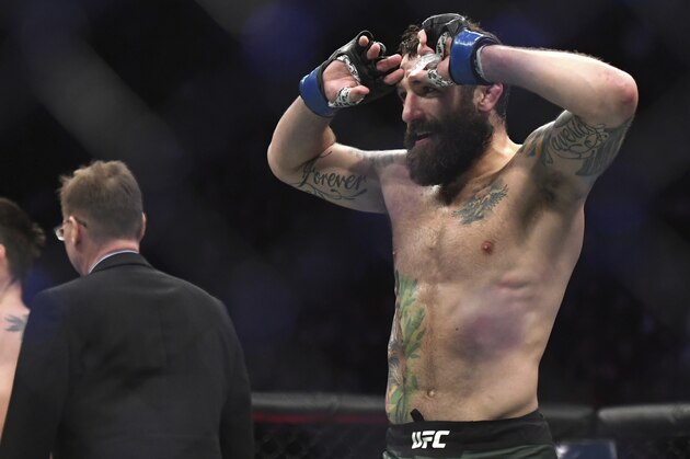 Michael Chiesa, right, celebrates his win over Carlos Condit in a welterweight mixed martial arts bout at UFC 232, Saturday, Dec. 29, 2018, in Inglewood, Calif. (AP Photo/Kyusung Gong)