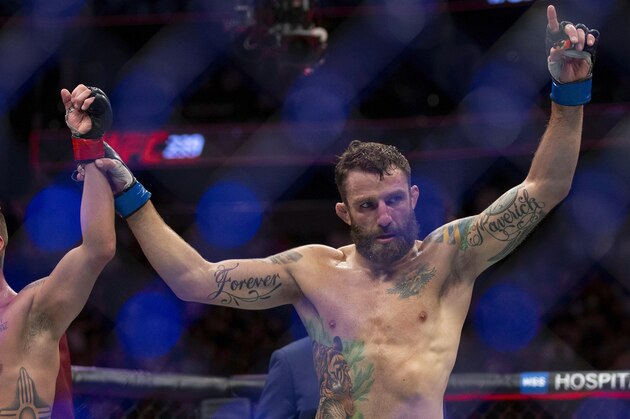 Michael Chiesa raises Diego Sanchez's arm just after their welterweight mixed martial arts bout at UFC 239, Saturday, July 6, 2019, in Las Vegas. Chiesa won by unanimous decision. (AP Photo/Eric Jamison)