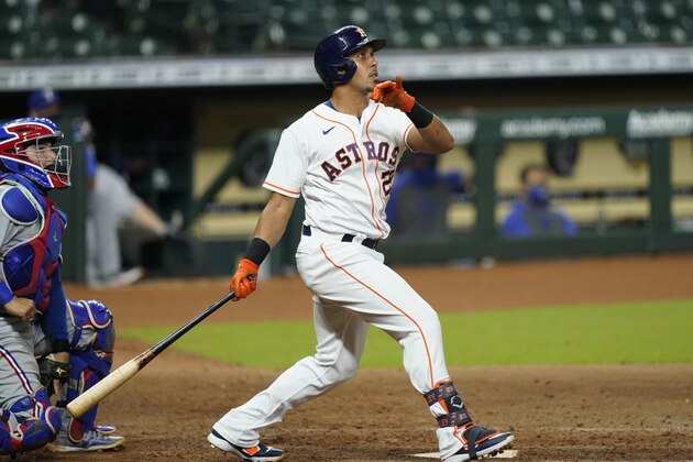 Houston Astros' Michael Brantley, right, watches his three-run home run along with Texas Rangers catcher Jose Trevino during the seventh inning of a baseball game Tuesday, Sept. 1, 2020, in Houston. (AP Photo/David J. Phillip)