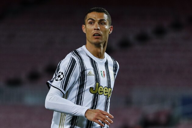 Juventus' Cristiano Ronaldo in action during the Champions League group G soccer match between FC Barcelona and Juventus at the Camp Nou stadium in Barcelona, Spain, Tuesday, Dec. 8, 2020. (AP Photo/Joan Monfort)