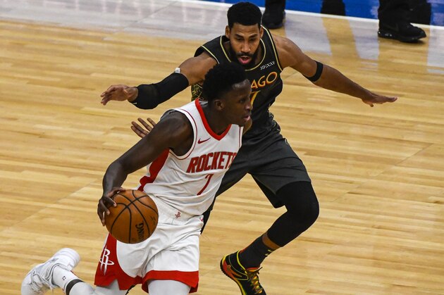 Houston Rockets guard Victor Oladipo (7) dribbles against Chicago Bulls guard Garrett Temple (17) during the second half of an NBA basketball game Monday, Jan. 18, 2021, in Chicago. (AP Photo/Matt Marton)