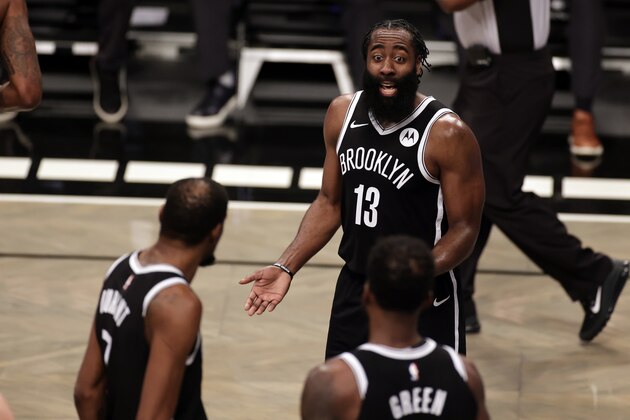 Brooklyn Nets guard James Harden (13) reacts towards forward Kevin Durant (7) and forward Jeff Green (8) during an NBA basketball game against the Milwaukee Bucks, Monday, Jan. 18, 2021, in New York. The Nets won 123-125. (AP Photo/Adam Hunger)