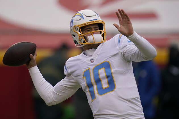 Los Angeles Chargers quarterback Justin Herbert warms up before the start of an NFL football game against the Kansas City Chiefs Sunday, Jan. 3, 2021, in Kansas City, Mo. (AP Photo/Jeff Roberson)