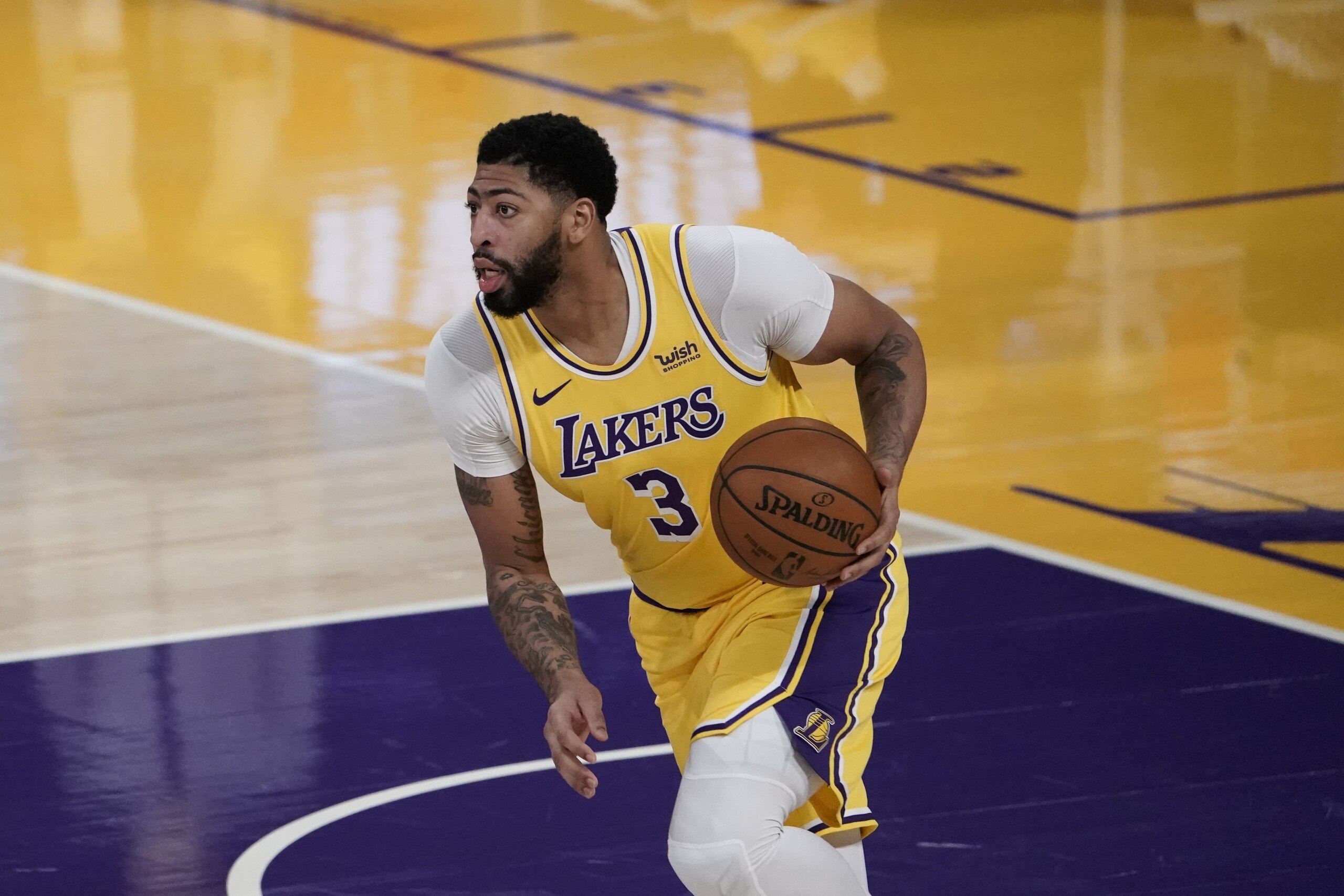 Los Angeles Lakers' Anthony Davis dribbles the ball during the first half of an NBA basketball game against the Golden State Warriors, Monday, Jan. 18, 2021, in Los Angeles. (AP Photo/Jae C. Hong)