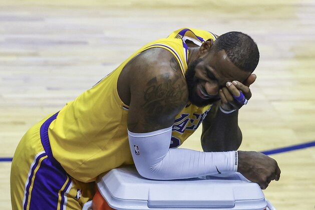 Los Angeles Lakers forward LeBron James reacts during a stop in play in the third quarter against the Houston Rockets in an NBA basketball game Tuesday, Jan. 21, 2021, in Houston. (Troy Taormina/Pool Photo via AP)