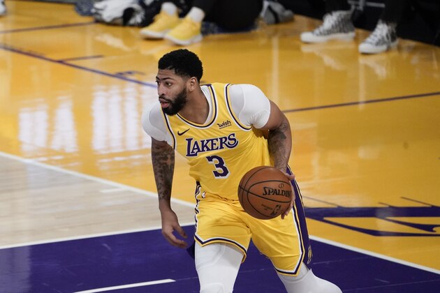 Los Angeles Lakers' Anthony Davis dribbles the ball during the first half of an NBA basketball game against the Golden State Warriors, Monday, Jan. 18, 2021, in Los Angeles. (AP Photo/Jae C. Hong)