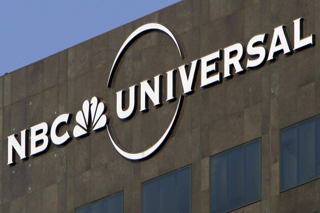 FILE - This Dec. 3, 2009, file photo, the NBC Universal logo hangs on a building in Los Angeles. Comcast’s NBCUniversal says its upcoming streaming service will be called Peacock, in an homage to NBC’s logo, and will be the home for some of the company’s most popular shows, including “Parks and Recreation,” “The Office” and “30 Rock.” (AP Photo/Jae C. Hong, File)