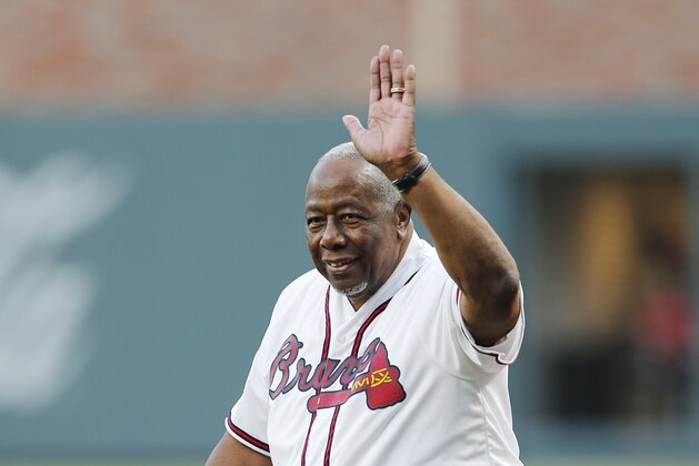 Former Atlanta Braves' Hank Aaron is honored during a ceremony before a baseball game between the Braves and the San Diego Padres in Atlanta, Friday, April 14, 2017. The Braves are playing their first regular-season game in SunTrust Park, the new suburban stadium that replaced Turner Field. (AP Photo/John Bazemore)