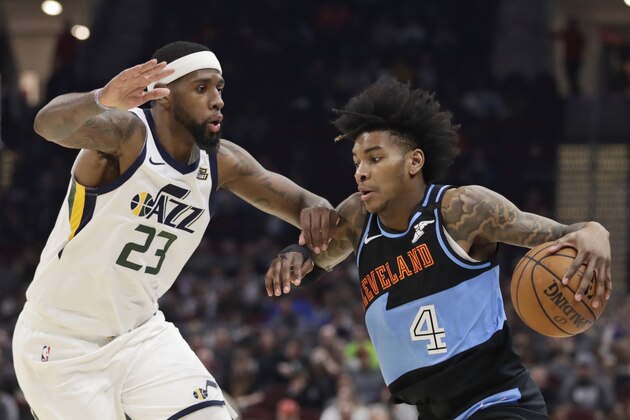 Cleveland Cavaliers' Kevin Porter Jr. (4) drives past Utah Jazz's Royce O'Neale (23) in the second half of an NBA basketball game, Monday, March 2, 2020, in Cleveland. (AP Photo/Tony Dejak)