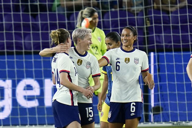 United States forward Megan Rapinoe (15) celebrates with teammates forward Emily Sonnett, left, and forward Lynn Williams (6) after scoring a goal against Colombia during the first half of an international friendly soccer match, Friday, Jan. 22, 2021, in Orlando, Fla. (AP Photo/John Raoux)