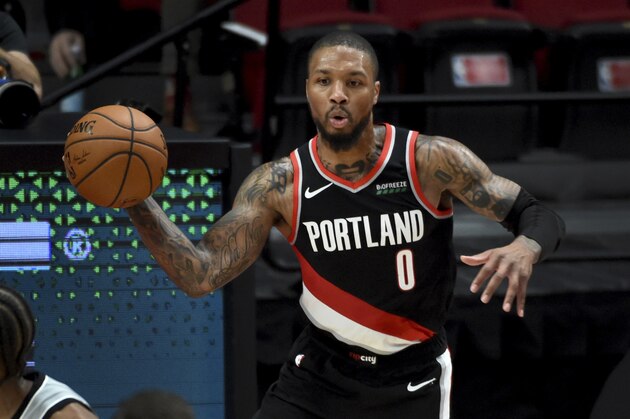Portland Trail Blazers guard Damian Lillard passes the ball during the second half of an NBA basketball game against the San Antonio Spurs in Portland, Ore., Monday, Jan. 18, 2021. The Spurs won 125-104. (AP Photo/Steve Dykes)