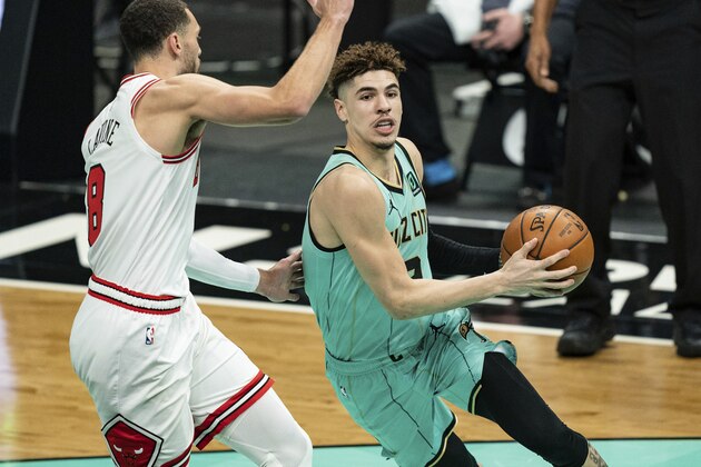 Charlotte Hornets guard LaMelo Ball (2) dribbles around Chicago Bulls guard Zach LaVine (8) during the first half of an NBA basketball game in Charlotte, N.C., Friday, Jan. 22, 2021. (AP Photo/Jacob Kupferman)