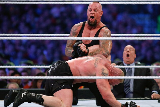 IMAGE DISTRIBUTED FOR WWE - The Undertaker, top, and Brock Lesnar wrestle during Wrestlemania XXX at the Mercedes-Benz Super Dome in New Orleans on Sunday, April 6, 2014. (Jonathan Bachman/AP Images for WWE)