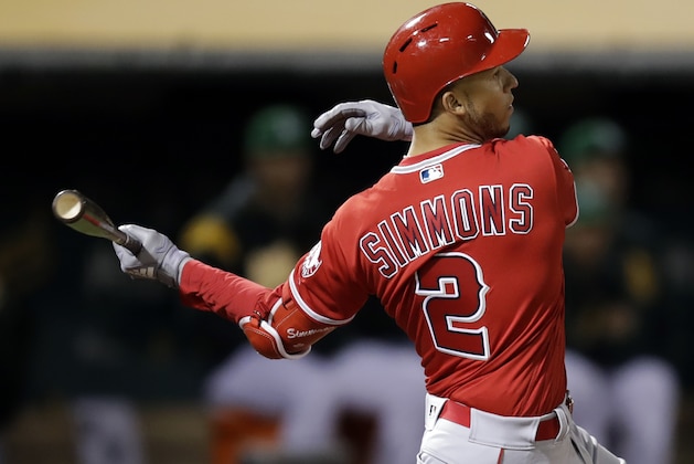 Los Angeles Angels' Andrelton Simmons follows through on a two-run single against the Oakland Athletics during the eighth inning of a baseball game Friday, March 29, 2019, in Oakland, Calif. (AP Photo/Ben Margot)