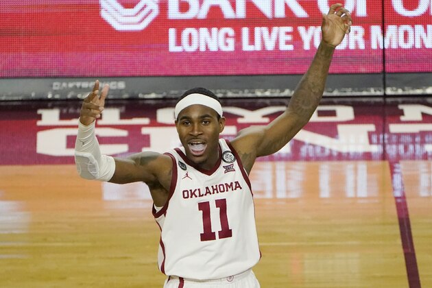 Oklahoma guard De'Vion Harmon (11) gestures to fans late in the second half of an NCAA college basketball game against West Virginia, Saturday, Jan. 2, 2021, in Norman, Okla. (AP Photo/Sue Ogrocki)