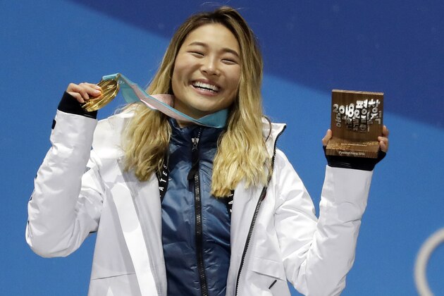 FILE - In this Feb. 13, 2018, file photo, women's halfpipe gold medalist Chloe Kim, of the United States, poses during the medals ceremony at the 2018 Winter Olympics in Pyeongchang, South Korea. Heading to Princeton next fall, Kim is trading her board for books as she tries to blend in and become your normal college freshman. (AP Photo/Morry Gash, File)